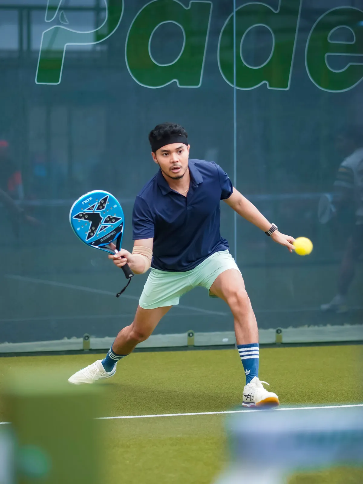 A padel player ready to hit the ball